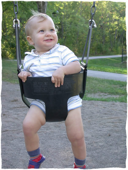Simon smiling on the swing